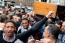 People mourn a victim of clashes between supporters and opponents of Egypt's military, at the Zinhom Morgue outside Cairo on January 26, 2014