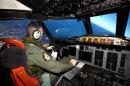 McAlevey sits in the cockpit of a RNZAF P3 Orion maritime search aircraft as it flies over the southern Indian Ocean looking for debris from missing Malaysian Airlines flight MH370