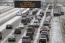 Traffic creeps along Interstate 55 in north Jackson, Miss., Tuesday, Jan. 28, 2014, as ice and snow flurries cause difficult driving conditions. A severe winter storm is expected to hit the state, bringing ice and snow to the Gulf Coast. (AP Photo/Rogelio V. Solis)