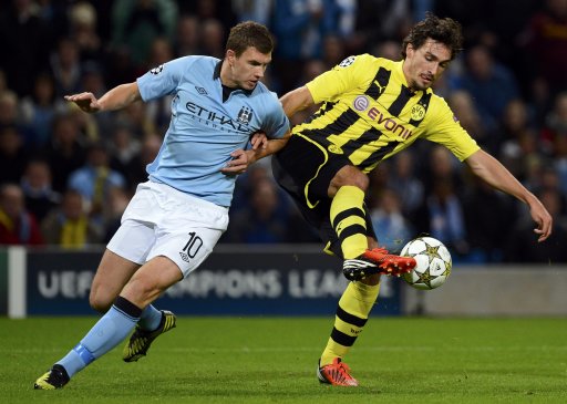 Manchester City's Dzeko challenges Borussia Dortmund's Hummels during their Champions League Group D soccer match in Manchester