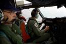 File photo of co-pilot and crewmen aboard an aircraft while on search for the missing Malaysian Airlines Flight MH370 over the southern Indian Ocean