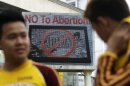 An anti-abortion sign flashes on an electric signboard outside the Roman Catholic Minor Basilica of the Black Nazarene in downtown Manila, Philippines on Thursday, Jan. 3, 2013. Philippine President Benigno Aquino III last month signed the Responsible Parenthood and Reproductive Health Act of 2012. The law that provides state funding for contraceptives for the poor pitted the dominant Roman Catholic Church in an epic battle against the popular Aquino and his followers. (AP Photo/Aaron Favila)