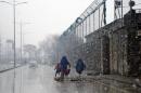 Burqa-clad Afghan women and a child walk during a snow storm in Kabul, Afghanistan, Tuesday, Feb. 24, 2015. (AP Photo/Massoud Hossaini)