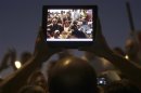 Egyptian protesters are pictured on a tablet device during a protest against general prosecutor Abdel Maguid Mahmoud and the Mubarak regime at Tahrir Square, the focal point of the Egyptian uprising, in Cairo