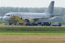 A Vueling plane parks at a field near Amsterdam Airport after a hijack scare
