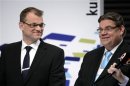 Centre Party Chairman Sipila laughs with True Finns Chairman Soini during Finnish municipal elections follow-up in Helsinki