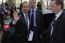 President-elect Francois Hollande, left, waves as he arrives at the Socialist Party headquarters in Paris Monday May 7, 2012. France handed the presidency to leftist Hollande, a champion of government stimulus programs who says the state should protect the downtrodden, a victory that could deal a death blow to the drive for austerity that has been the hallmark of Europe in recent years. (AP Photo/Michel Spingler)