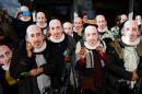 Wearing masks of the "Bard of Avon", members of the public prepare for the parade marking 400 years since the death of William Shakespeare, in Stratford-upon-Avon on April 23, 2016