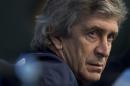 Manchester City manager Manuel Pellegrini waits to answer questions during a press conference at the Etihad Stadium, Manchester, England, Monday Feb. 17, 2014. Manchester City will play Barcelona on Tuesday in a Champions League first knock out round soccer match. (AP Photo/Jon Super)