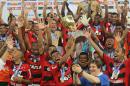 Flamengo celebrates with their trophy after their Rio de Janeiro state championship final soccer match with Vasco at Maracana stadium in Rio de Janeiro, Brazil, Sunday, April 13, 2014. The match ended in a draw which favored Flamengo. (AP Photo/Leo Correa)
