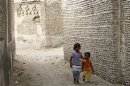 Children walk through a street in the historical city of Zabid