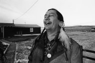 FILE - In a Feb. 4, 1974 file photo, American Indian Movement (AIM) leader Russell Means, who is challenging incumbent Oglala Sioux Tribal President Richard Wilson in Thursday's election on the Pine Ridge Indian Reservation, laughs at news report which quoted Wilson as saying he will give AIM 10 days to get off the reservation after he is reelected "or else", in Pine Ridge, S.D. Means, a former American Indian Movement activist who helped lead the 1973 uprising at Wounded Knee, reveled in stirring up attention and appeared in several Hollywood films, died early Monday, Oct. 22, 2012 at his ranch in in Porcupine, S.D., Oglala Sioux Tribe spokeswoman Donna Solomon said. He was 72. (AP Photo/Jim Mone, File)