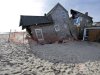 FILE - In this Jan. 3, 2013 photo, a beach front home that was severely damaged by Superstorm Sandy rests in the sand in Bay Head, N.J.   (AP Photo/Mel Evans)