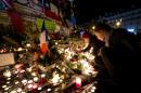 Candles blaze on the evening of November 15, 2015 in the Place de la Republique in Paris, where a makeshift memorial has sprung up to honor victims of the November 13 jihadist attacks that killed at least 129 in the French capital