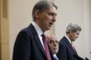 Iraq's Prime Minister Haider al-Abadi and U.S. Secretary of State John Kerry listen as Britain's Foreign Secretary Philip Hammond speaks during a news conference at the Foreign Office in London