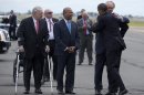 President Barack Obama is greeted by Massachusetts Senate candidate, Rep. Ed Markey, right, accompanied by Boston Mayor Thomas Menino, left, and Massachusetts Gov Deval Patrick, center, upon his arrival at Logan International Airport in Boston, Wednesday, June 12, 2013. Obama traveled to Boston to campaign for Markey's Massachusetts Democratic Senate campaign. (AP Photo/Evan Vucci)