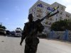 A Somali government soldier patrols the scene of an explosion in the capital of Mogadishu