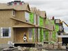 Construction workers work on building new homes in Calgary, Alberta
