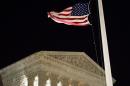 A U.S. flag flies at half-staff in front of the U.S. Supreme Court in Washington Saturday, Feb. 13, 2016, after is was announced that Supreme Court Justice Antonin Scalia, 79, had died. (AP Photo/J. David Ake)