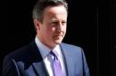Britain's Prime Minister David Cameron leaves 10 Downing Street as he names his new cabinet, in central London, Britain