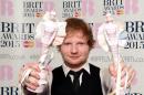 British singer-songwriter Ed Sheeran poses with his British album of the year award for 'X' and his British male solo artist award at the BRIT Awards 2015 in London on February 25, 2015