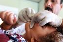 An Iraqi child gets vaccinated in Baghdad, on November 1, 2015, as part of a major vaccination campaign started to combat a cholera outbreak