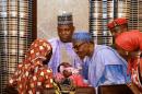 Amina Ali Darsha Nkeki presents her child to President Muhammadu Buhari in Abuja