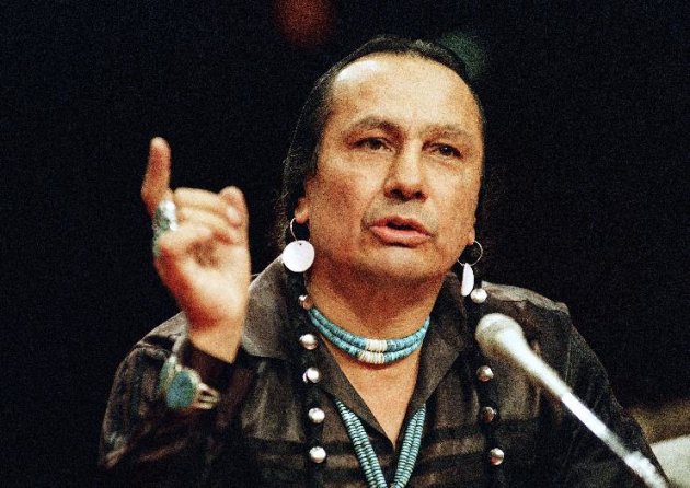 FILE - In a Jan. 31, 1989 file photo, Russell Means, who heads the American Indian Movement, (AIM) testifies before a special investigative committee of the Senate Select Committee on Capitol Hill, in Washington. Means, a former American Indian Movement activist who helped lead the 1973 uprising at Wounded Knee, reveled in stirring up attention and appeared in several Hollywood films, died early Monday, Oct. 22, 2012 at his ranch Zzxin Porcupine, S.D., Oglala Sioux Tribe spokeswoman Donna Solomon said. He was 72. (AP Photo/Marcy Nighswander, File)
