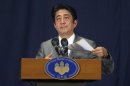 Japan's PM Abe speaks during a news conference in Doha