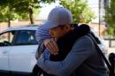 In this Aug. 14, 2016 photo, Mahdi Azizi hugs his mother goodbye before boarding a bus to return to a centre for unaccompanied minors, in Vasteras, Sweden. Love, not war, made the Azizi family flee Iran during last summer's chaotic mass migration to Europe. Luck reunited them a year after a dark night in a Turkish forest separated 14-year-old Mahdi Azizi from his parents and sisters. (AP Photo/David Keyton)