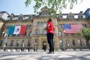 The Mexican and U.S. flags hang from the Langevin Block in advance of the North American Leaders' Summit in Ottawa
