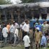 Railway workers and officials inspect the burnt coach of a passenger train at Nellor nearly 500 kilometers (310 miles) south of Hyderabad, India, July 30, 2012. A fire engulfed a passenger car on a moving train in southern India on Monday, killing at least 47 people, officials said.  (AP Photo)