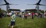 A boy runs past the V-22 Osprey during a demonstration put together by the Marines as a part of Fleet Week in East Meadow, New York