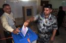 An Iraqi federal policeman casts his vote at a polling center in Baghdad, Iraq, Monday, April 28, 2014. Amid tight security, some one million Iraqi army and police personnel have started voting for the nation's new parliament. (AP Photo/Khalid Mohammed)