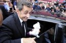 Former French president Nicolas Sarkozy leaves by car after a lunch with UMP political party members in Nice