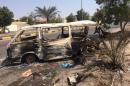 The wreckage of a minivan is seen on a street in Yemen's southern port city of Aden
