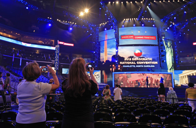 Visitors take photos of the main stage during the public unveiling of Democratic National Convention's facilities at Time Warner Arena in Charlotte, N.C., Friday, Aug. 31, 2012. (AP Photo/Chuck Burton)