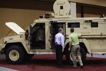 Attendees look at the Lenco MRAP Bear SWAT Team vehicle at 7th annual Border Security Expo in Phoenix