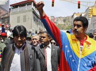 Venezuela's Vice President Nicolas Maduro (R) and Bolivia's President Evo Morales (L) walk ahead of the vehicle carrying the coffin of deceased Venezuelan leader Hugo Chavez, as it is driven through the streets of Caracas after leaving the military hospital where he died of cancer in Caracas, March 6, 2013. Authorities have not yet said where Chavez will be buried after his state funeral on Friday. REUTERS/Carlos Garcia Rawlins