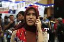 A woman uses her mobile during the Digital Imaging Expo in Jakarta