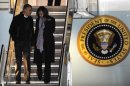 President Barack Obama and first lady Michelle Obama walk off Air Force One after arriving at O'Hare International Airport in Chicago, Tuesday, Nov. 6, 2012. (AP Photo/Paul Beaty)