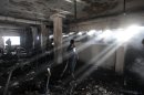 Bangladeshi workers inspect the damage inside a two-storied garment factory that caught fire in Dhaka, Bangladesh, Saturday, Jan.26, 2013. The fire killed at least six female workers and injured another five, police and fire officials said. The latest fire occurred more than two months after a deadly fire killed 112 workers in another factory near the capital city, raising questions about the safety measures in Bangladesh garment industry. (AP Photo/A.M. Ahad)