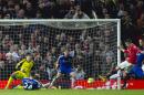 Manchester United's Robin van Persie, right, scores against Chelsea during the English Premier League soccer match between Manchester United and Chelsea at Old Trafford Stadium, Manchester, England, Sunday Oct. 26, 2014. (AP Photo/Jon Super)