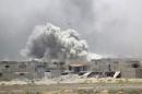 Smoke rises from clashes with Islamic State militants in Falluja