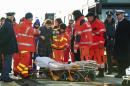An injured passenger is being eased to a stretcher as she and some 40 of the survivors of the Norman Atlantic ferry fire, finally stepped ashore, in the port of Taranto, Italy, Wednesday, Dec. 31, 2014. They arrived by one of the cargo ships that took aboard passengers from the flaming, smoke-shrouded ferry in the first hours after the blaze down in the car deck sent people, shaken out of their sleep, to scrambling for their lives and take shelter -- in freezing cold, pelted by rain and buffeted by gale-force wind on the top, uncovered deck. (AP Photo/Cosimo Calabrese)