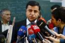 Demirtas, co-chairman of the pro-Kurdish Peoples' Democratic Party (HDP), talks to the media before casting his ballot at a polling station