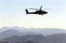 A U.S Army Apache helicopter flies near the town of Walli Was during an operation in Paktika province, near the border with Pakistan