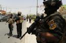 Iraqi special forces keep watch as they secure a district in West Baghdad, on June 18, 2014