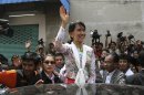 Myanmar opposition leader Aung San Suu Kyi waves while leaving a community center in Samut Sakhon Province, Thailand on Wednesday, May 30, 2012. Kicking off her first trip abroad in nearly a quarter-century, Suu Kyi offered encouragement Wednesday to impoverished Myanmar migrants whose flight to neighboring Thailand is emblematic of the devastation wrought on her homeland by decades of misrule.(AP photo/Sakchai Lalit)