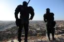 Algerian security forces stand guard on a ridge looking down on the city of Ghardaia on March 18, 2014
